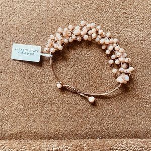Adjustable, beaded, sparkly bracelet, very light pink.